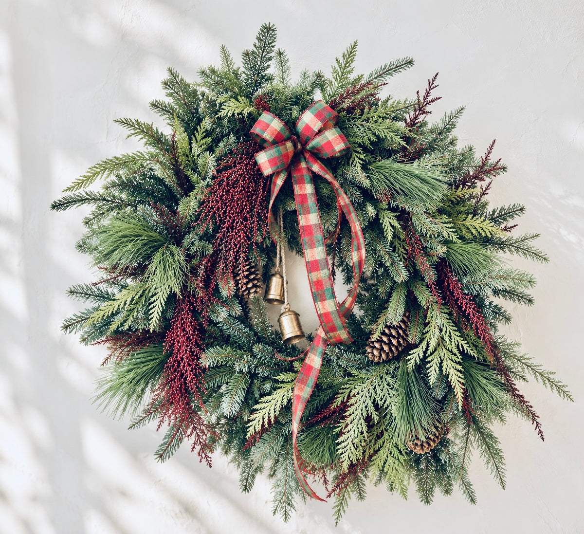 Handmade Christmas wreath with evergreens, magnolia, seeded eucalyptus and velvet ribbon